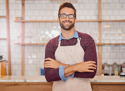Buy stock photo Portrait of a happy business owner posing behind the counter in his coffee shop