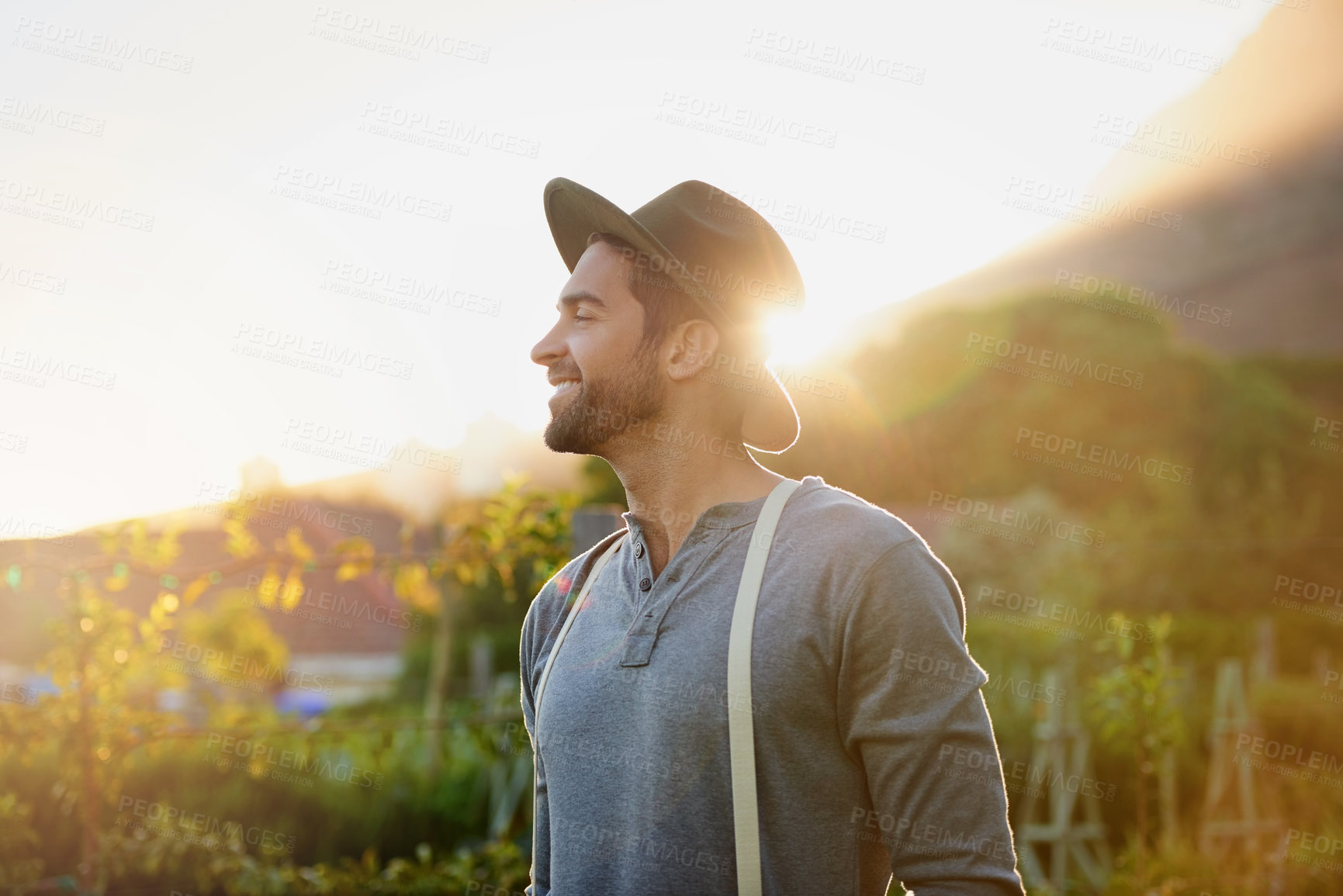 Buy stock photo Farmer, thinking and farming in sunset with growth, plants and field of plants, vegetables or sustainable business. Young gardener or man with agriculture crops or land for development by countryside