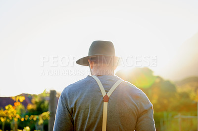 Buy stock photo Rearview shot of a man working on a farm