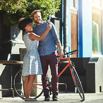 Buy stock photo Happiness, selfie and diversity couple of city friends with outdoor picture memory of date, romance or morning bike commute. Bicycle, urban bonding and marriage people post photo to social media app