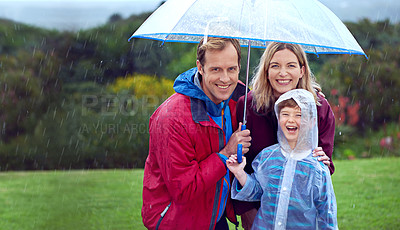 Buy stock photo Family, happy and portrait in rain with umbrella in nature outdoor for fun, happiness and quality time. Man, woman and boy child with protection for water drops with freedom while playing in winter