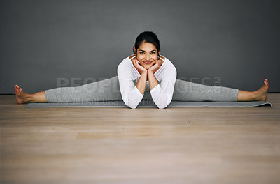 Buy stock photo Portrait of an attractive young woman doing the splits in her yoga routine