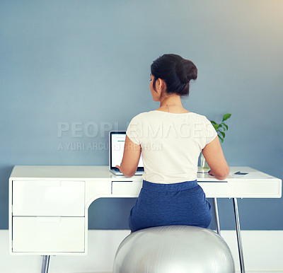 Buy stock photo Cropped shot of a young businesswoman working on her laptop at home