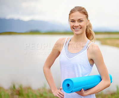 Buy stock photo Portrait of a happy young woman doing yoga next to a lake outside