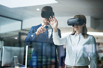 Buy stock photo Multiple exposure shot of two coworkers brainstorming together in the office while wearing VR headsets