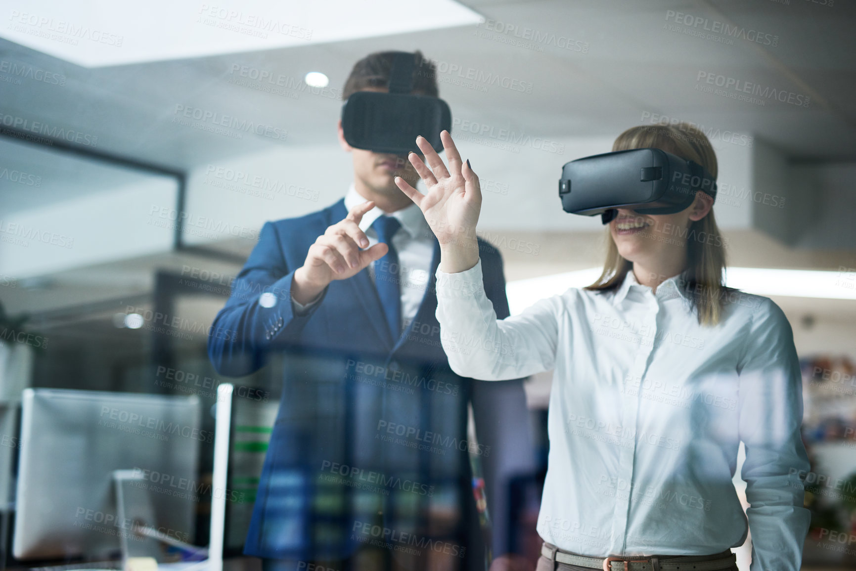 Buy stock photo Multiple exposure shot of two coworkers brainstorming together in the office while wearing VR headsets