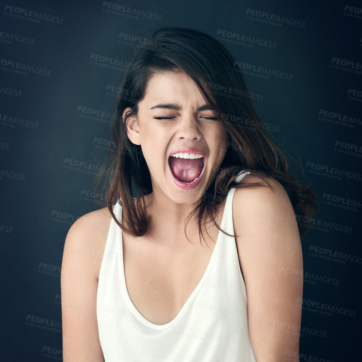 Buy stock photo Cropped shot of a beautiful young woman shouting against a dark background
