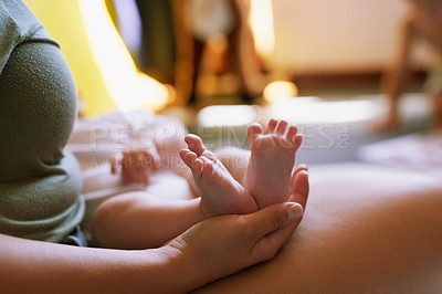 Buy stock photo Cropped shot of a mother holding her baby’s feet