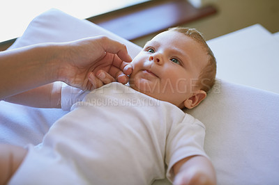 Buy stock photo Cropped shot of a mother tenderly caressing her baby son’s cheek