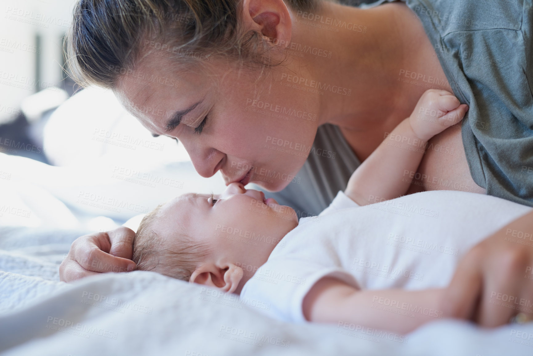 Buy stock photo Mom, baby and happy with kiss on bed in home for support, love and care for growth and child development. Parent, kid and happy in bedroom with playing for bonding, childhood memories and toddler