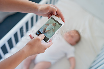 Buy stock photo Closeup shot of a mother taking a picture of her baby boy on a cellphone
