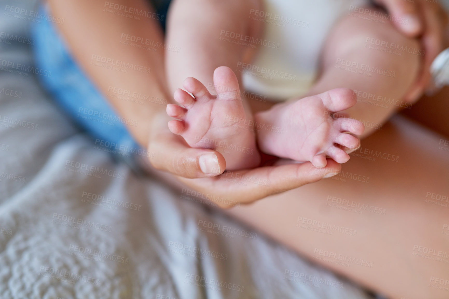 Buy stock photo Cropped shot of a mother holding her baby’s feet