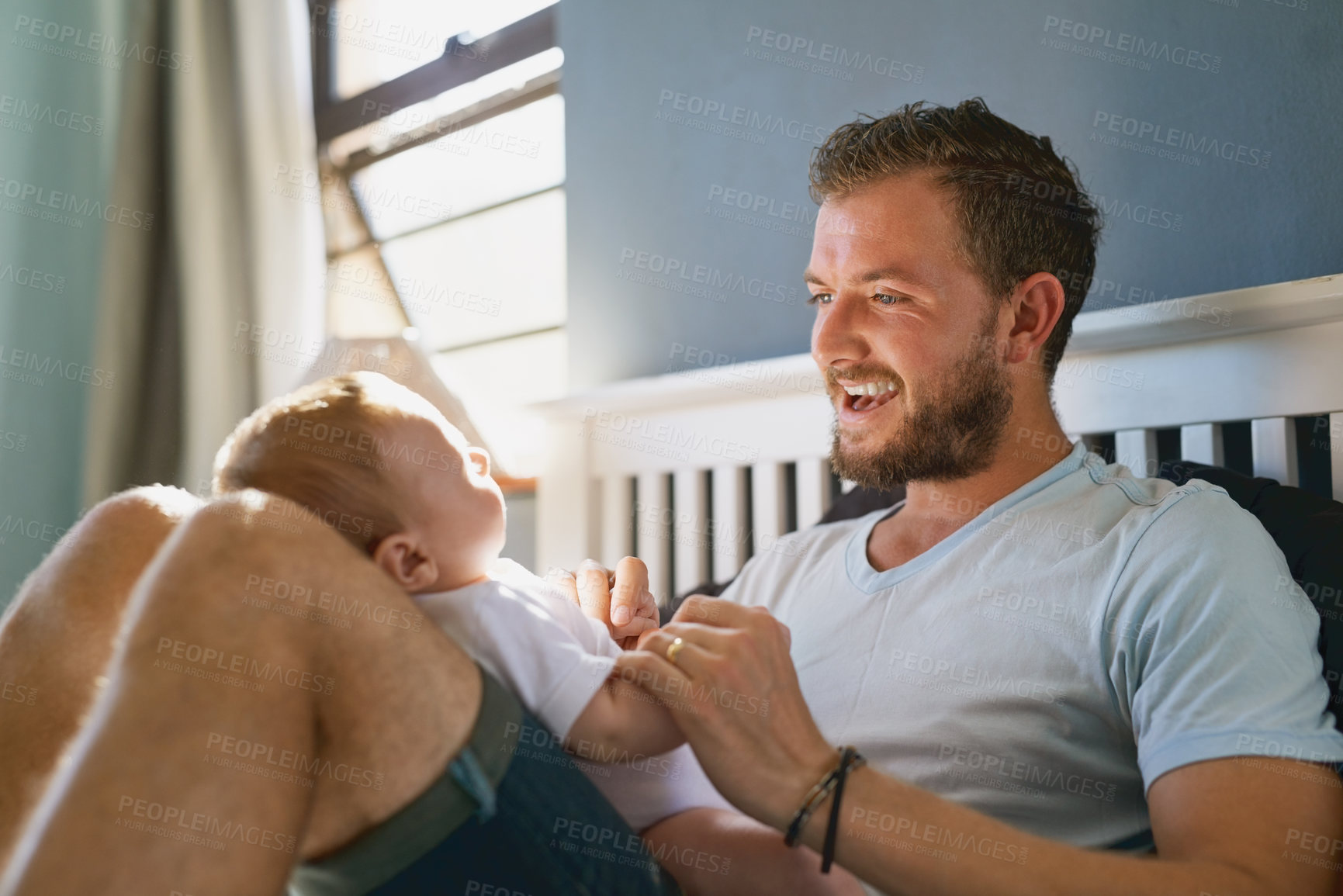 Buy stock photo Home, father and baby in bed for playing, growth and child development with single parent with happiness. Family, proud dad and boy infant in house with game, comfort and energy with newborn son