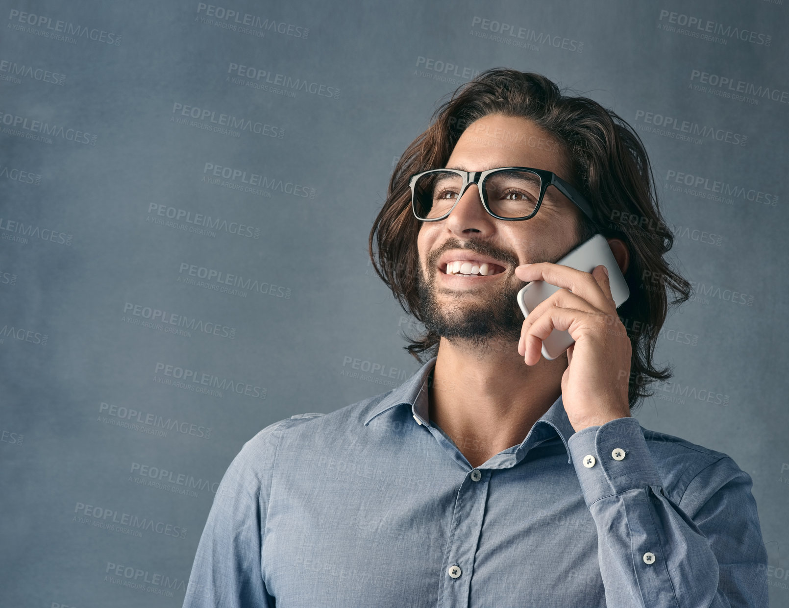 Buy stock photo Happy businessman, thinking and listening with phone call for communication on a gray studio background. Young male person or employee talking with smile on mobile smartphone for business discussion