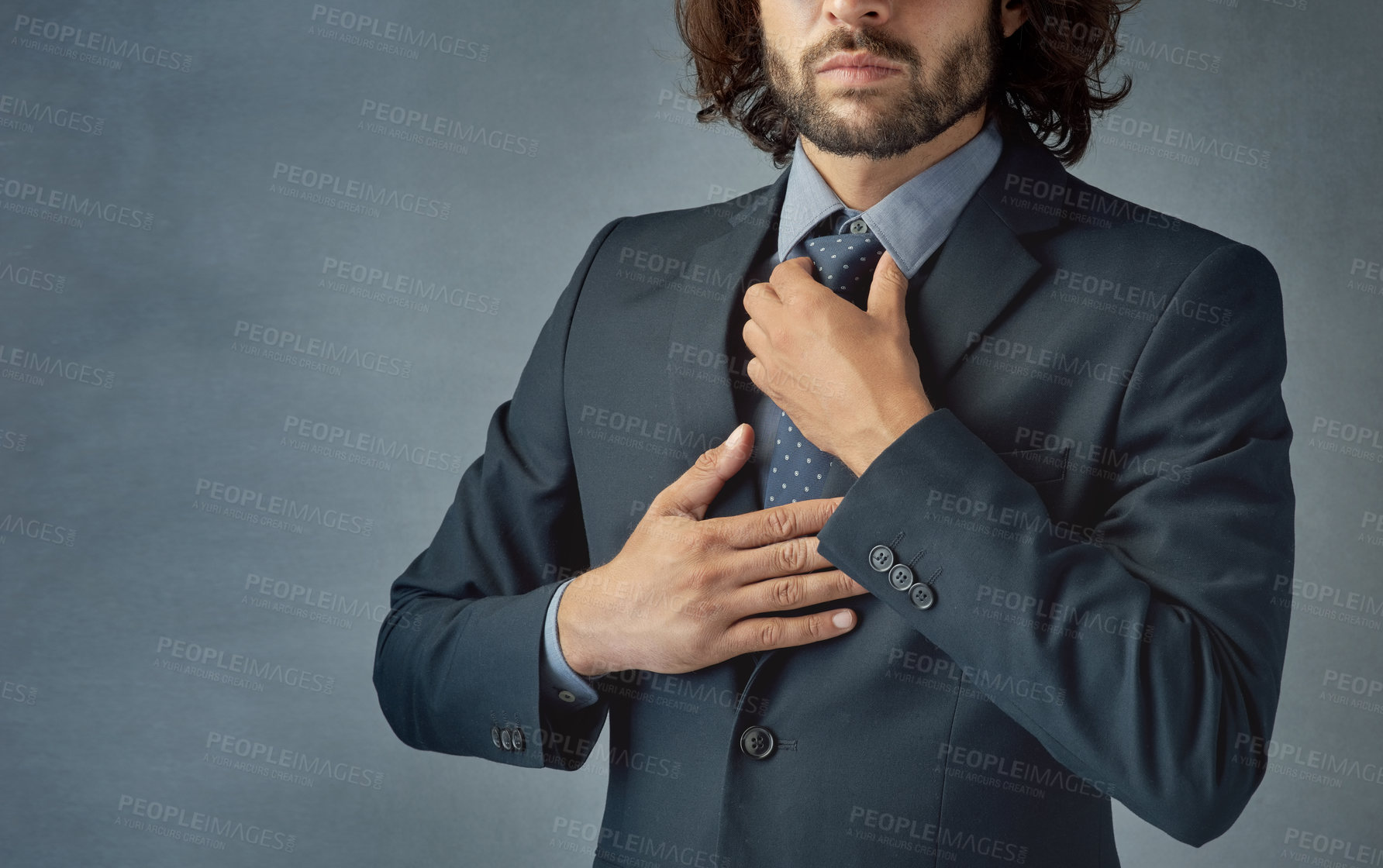 Buy stock photo Cropped shot of a stylishly dressed young man adjusting his tie