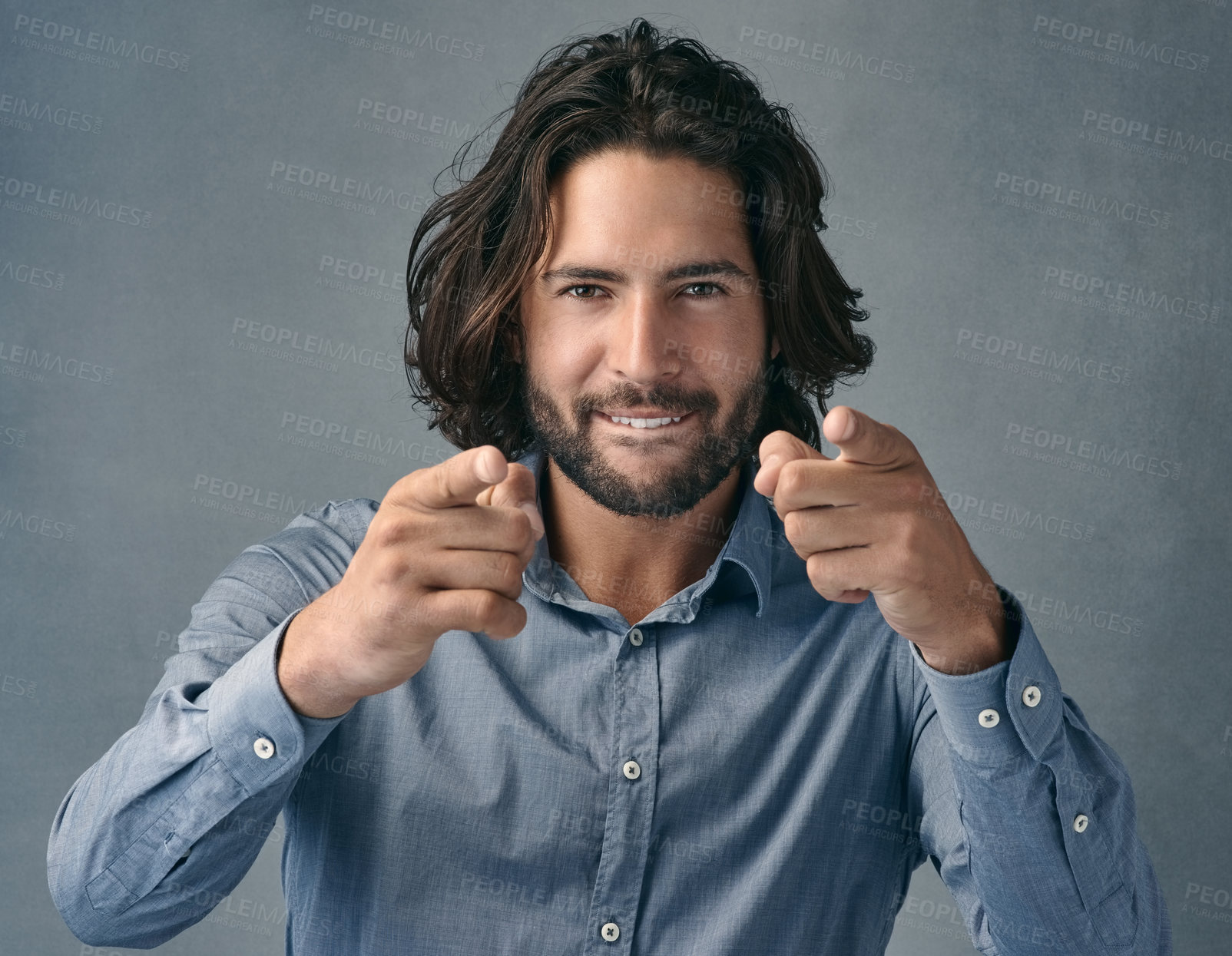 Buy stock photo Studio shot of a handsome young man pointing at the camera against a grey background