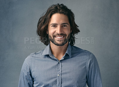 Buy stock photo Cropped shot of a handsome young man posing against a grey background