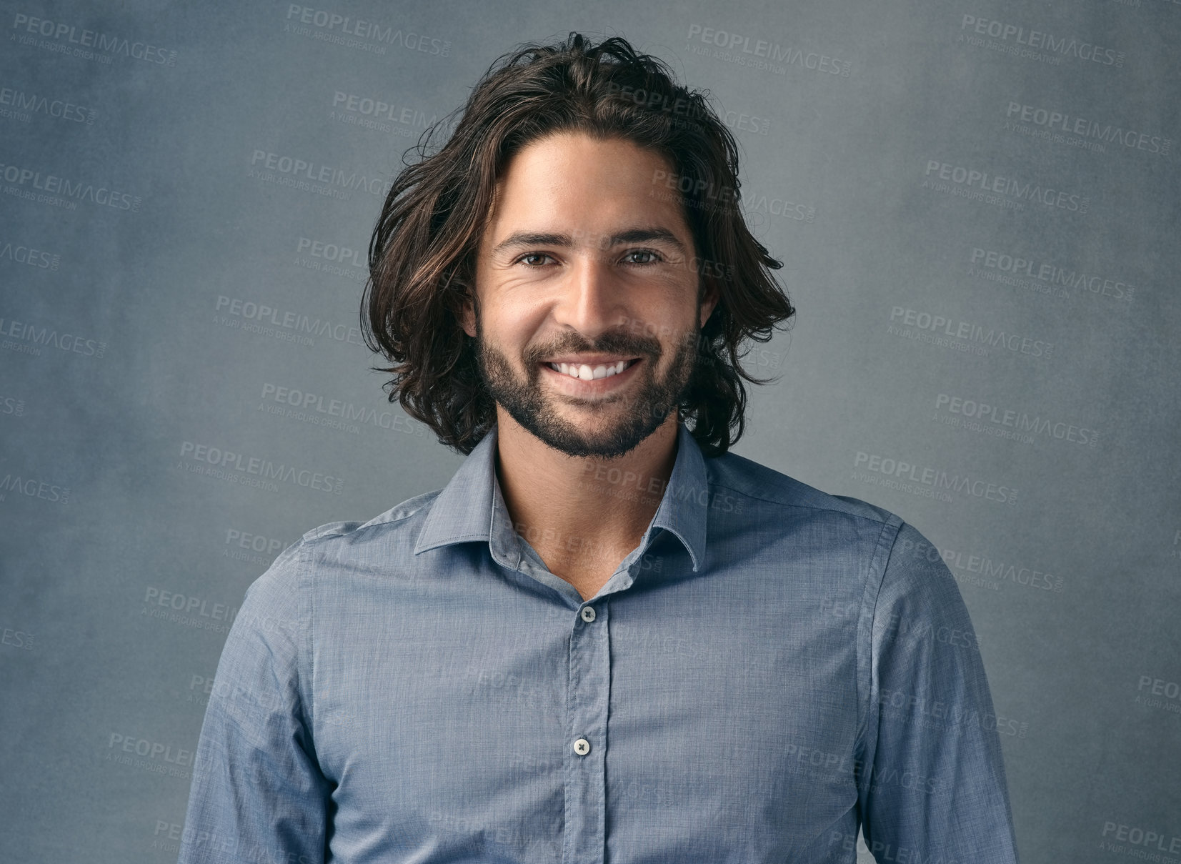 Buy stock photo Cropped shot of a handsome young man posing against a grey background