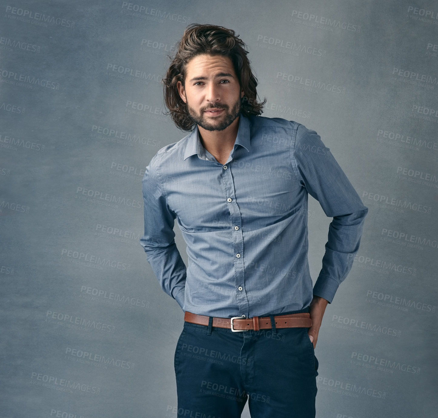 Buy stock photo Cropped shot of a handsome young man posing against a grey background