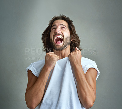 Buy stock photo Studio shot of a young man screaming against a grey background