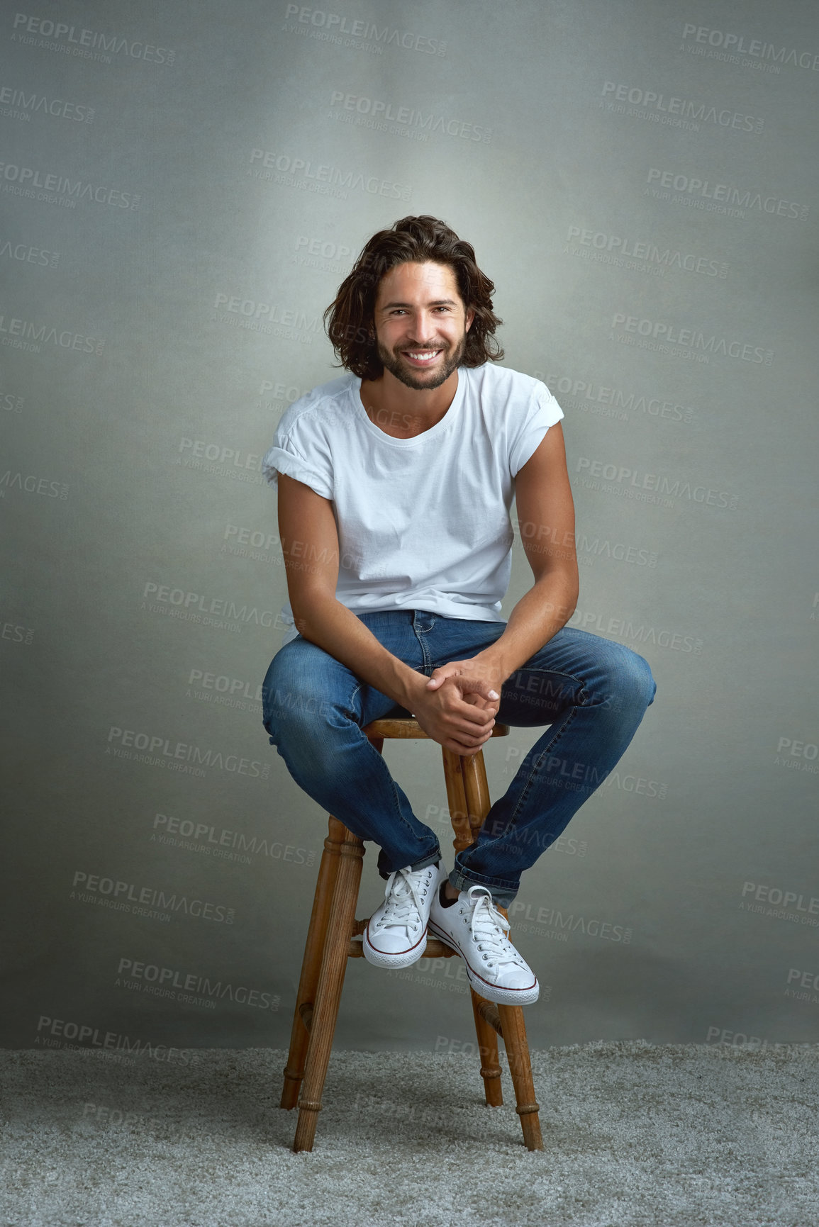 Buy stock photo Studio portrait of a handsome young man posing against a grey background