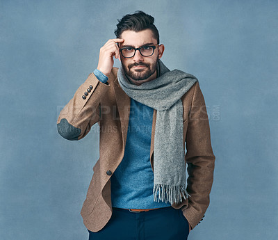 Buy stock photo Studio shot of a stylishly dressed young man posing against a grey background