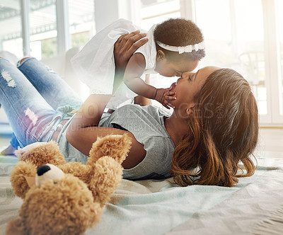 Buy stock photo Love, black woman and baby bonding on floor with kiss and happiness playing together in living room. Smile, mother and daughter in happy house, spending quality time for parent and newborn in home.