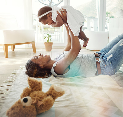 Buy stock photo Laughing black woman, baby and playing on living room floor with love, toys and happiness in bonding together. Smile, mother and daughter in happy embrace, quality time for parent and newborn in home