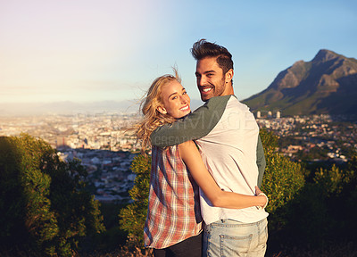 Buy stock photo Portrait of an affectionate young couple admiring the view outdoors