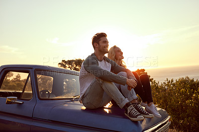 Buy stock photo Shot of a young couple admiring the view while enjoying a roadtrip together