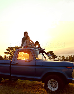 Buy stock photo Shot of a young couple admiring the view while enjoying a roadtrip together