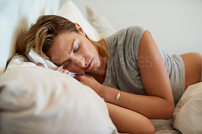 Buy stock photo Cropped shot of an attractive woman sleeping on her side in bed at home
