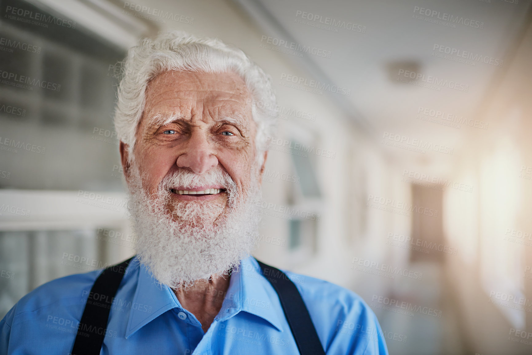 Buy stock photo Portrait of a happy senior man posing in the hallway of his nursing home