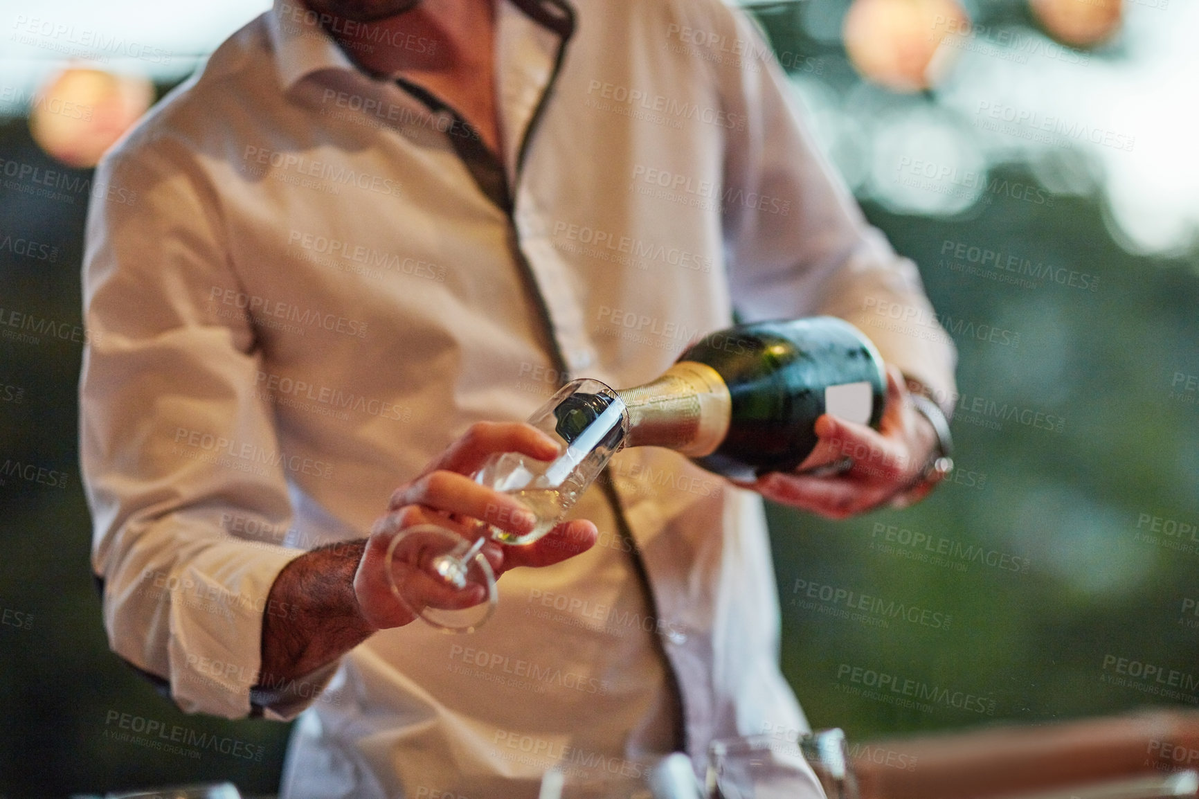 Buy stock photo Champagne, glass and pour with hands of barman in restaurant for hospitality or service closeup. Alcohol, drink and wine with person serving beverage at event for celebration, milestone and toast