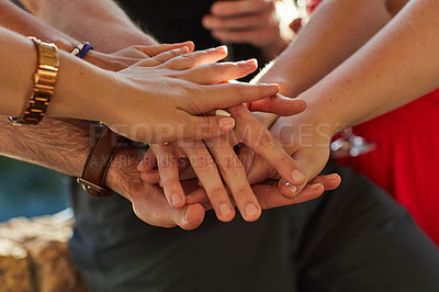 Buy stock photo Shot of a group of unidentifiable friends putting their hands in a pile at an outdoor party