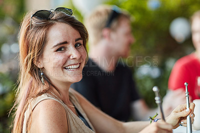 Buy stock photo Portrait of a happy young woman sharing a meal with friends at an outdoor dinner party