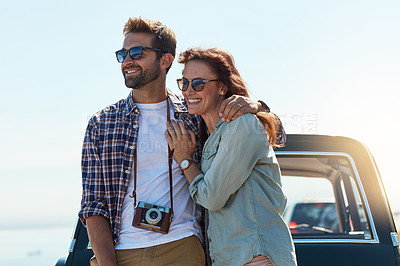 Buy stock photo Happy couple, outdoor and hug by car for road trip with camera for journey documentation, explore and bonding. Man, woman and together for scenic drive, travel photography and adventure with love.