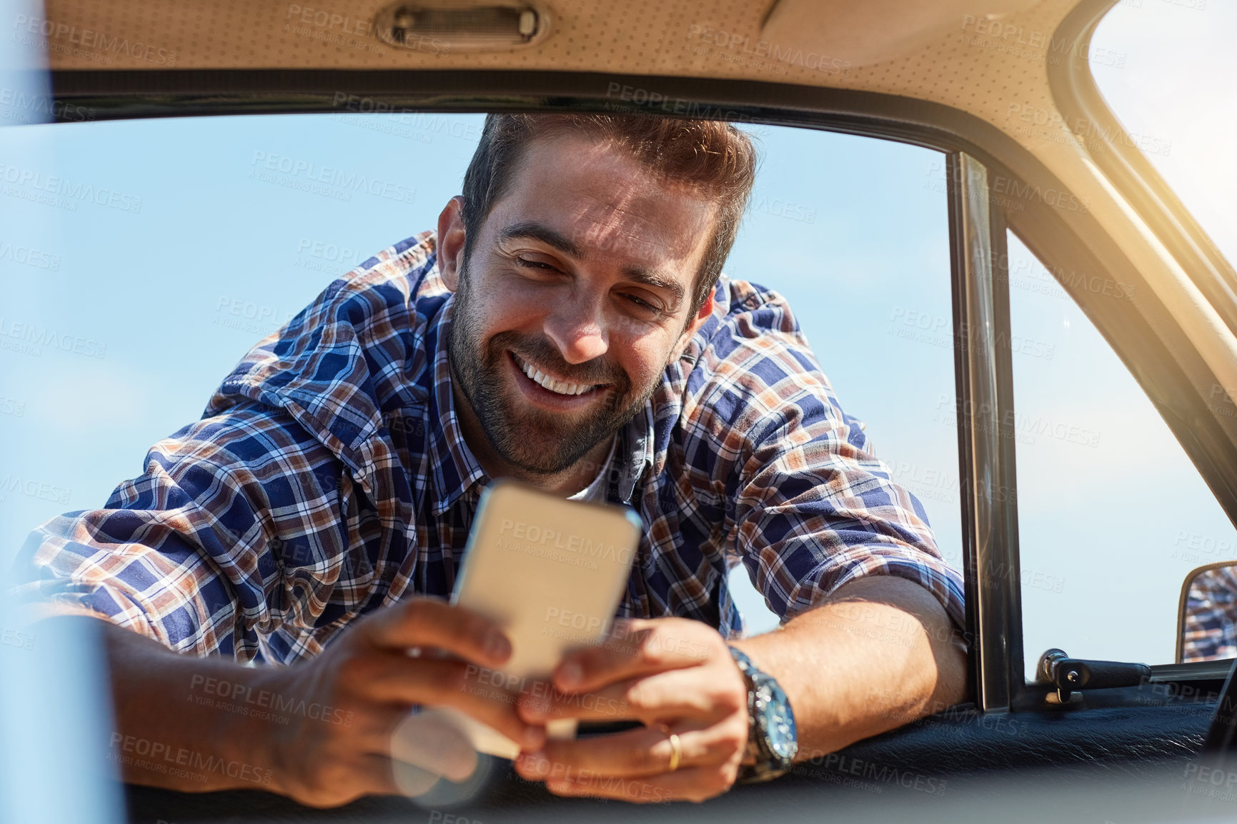 Buy stock photo Road trip, break and man with phone by car for summer vacation, adventure or update on journey. Happy, person and relax with tech by window for communication, tourism or map location check in Germany