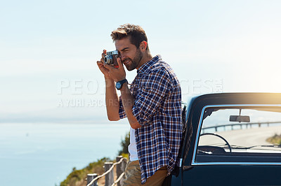 Buy stock photo Cropped shot of a handsome man taking photos while enjoying a road trip