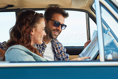 Buy stock photo Cropped shot of an affectionate couple checking a map while enjoying a road trip