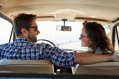 Buy stock photo Rearview shot of an affectionate couple enjoying a summer road trip