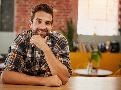 Buy stock photo Portrait of a confident young business owner posing at the counter in his coffee shop