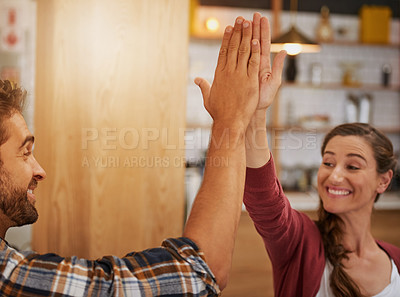 Buy stock photo Shot of two enthusiastic young business owners high fiving each other in their coffee shop