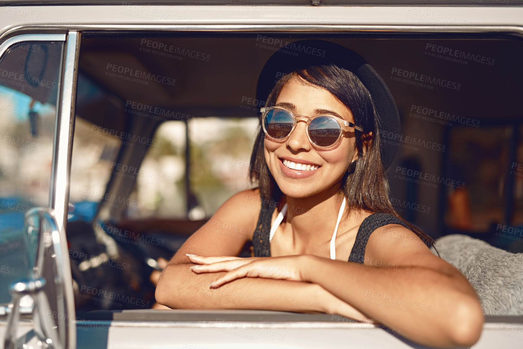 Buy stock photo Shot of a happy young woman going on a road trip