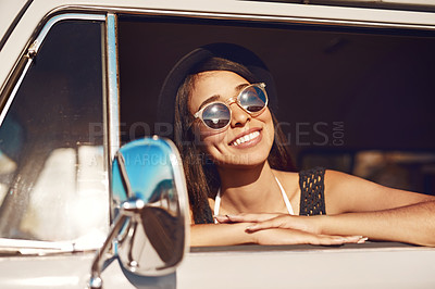 Buy stock photo Shot of a happy young woman going on a road trip