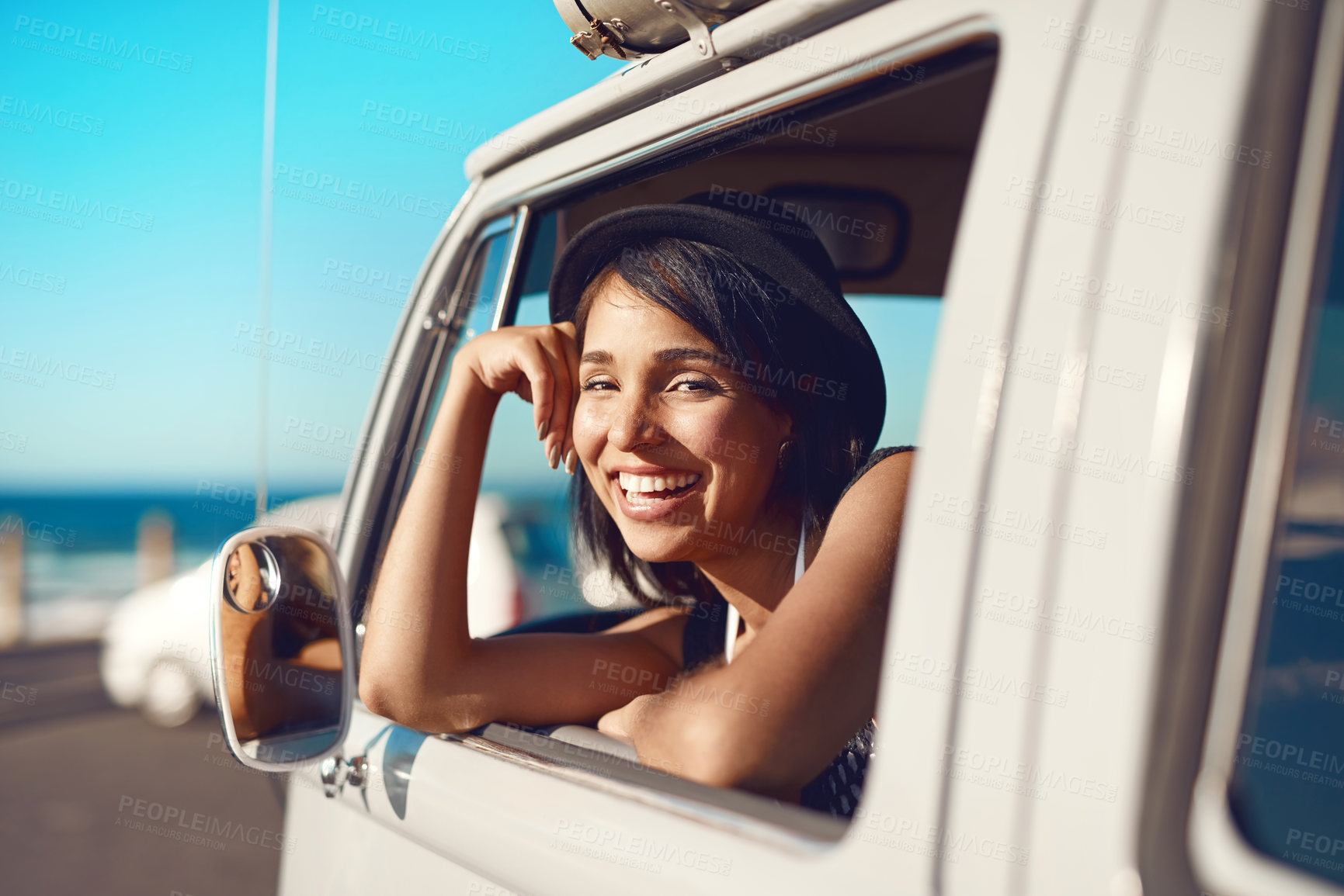 Buy stock photo Shot of a happy young woman going on a road trip