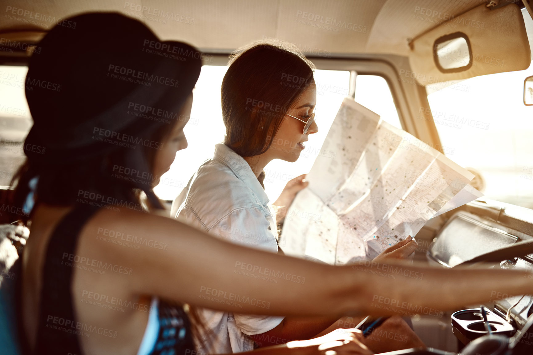 Buy stock photo Girls, friends and drive on car with map for direction, route and navigate on road trip in Brazil. People, tourist and journey with location or destination for traveling, adventure and summer holiday