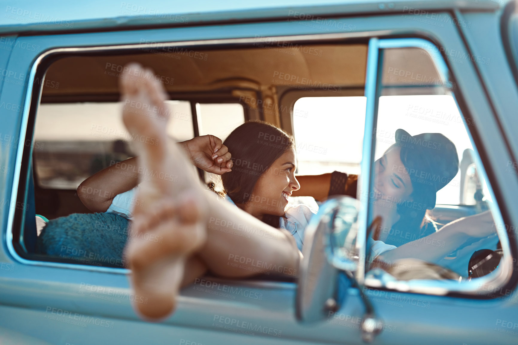 Buy stock photo Relax, smile and lesbian couple on road trip in van at sunset in countryside for holiday. Happy, love and queer women in vehicle for bonding, talking and traveling together on vacation with adventure