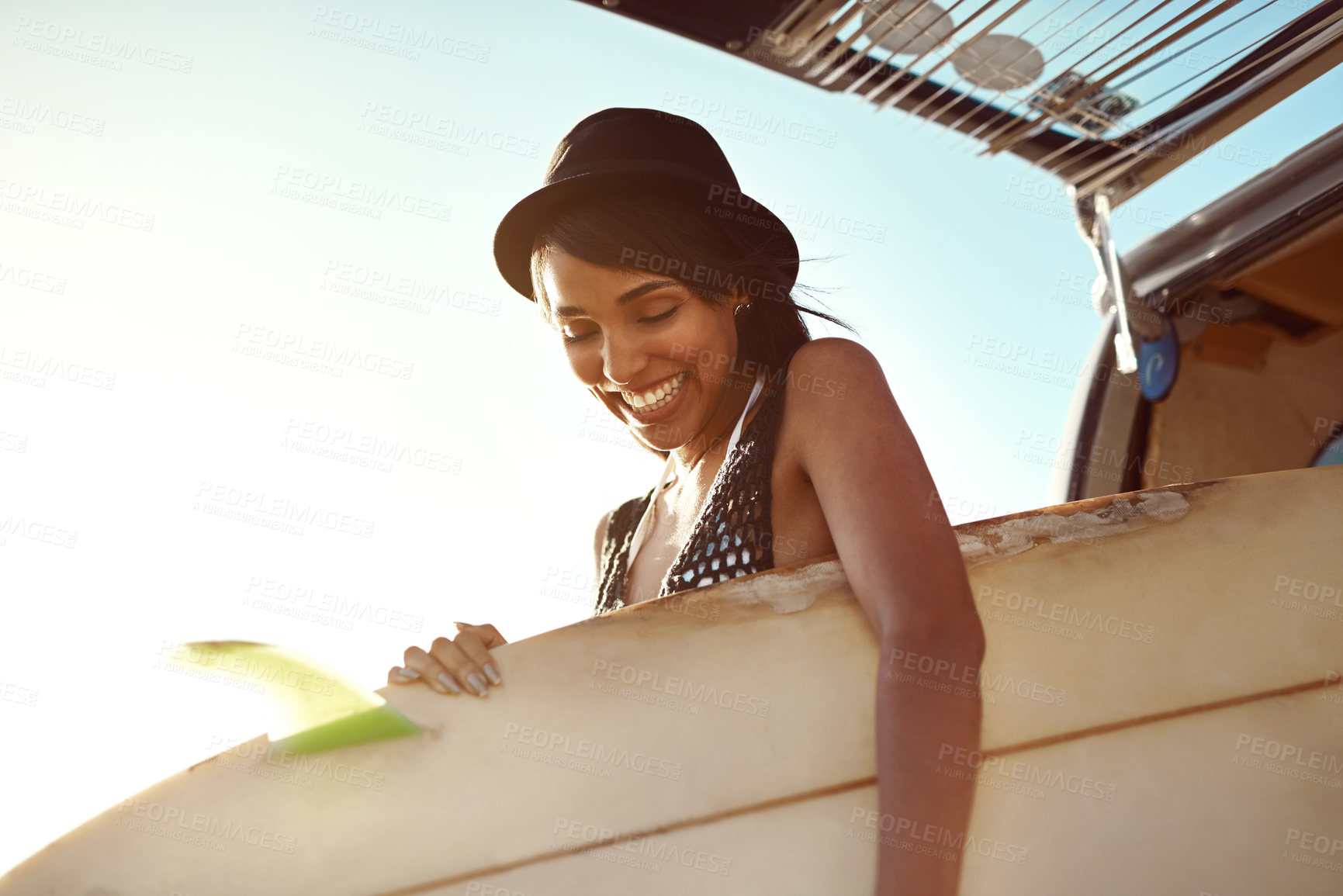 Buy stock photo Woman, surfboard and happy by car for road trip in summer for beach, adventure and outdoor on holiday in nature. Person, surfer and smile by vehicle for transport in sunshine for vacation in Brazil