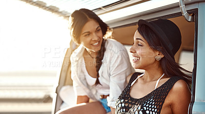 Buy stock photo Shot of two happy young friends enjoying a relaxing road trip